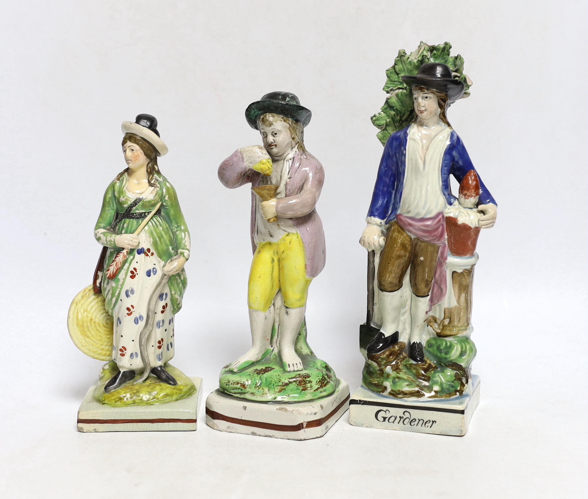 Three Staffordshire pearlware figures of a boy with grapes, a lady archer and a 'Gardener', largest 22cm high